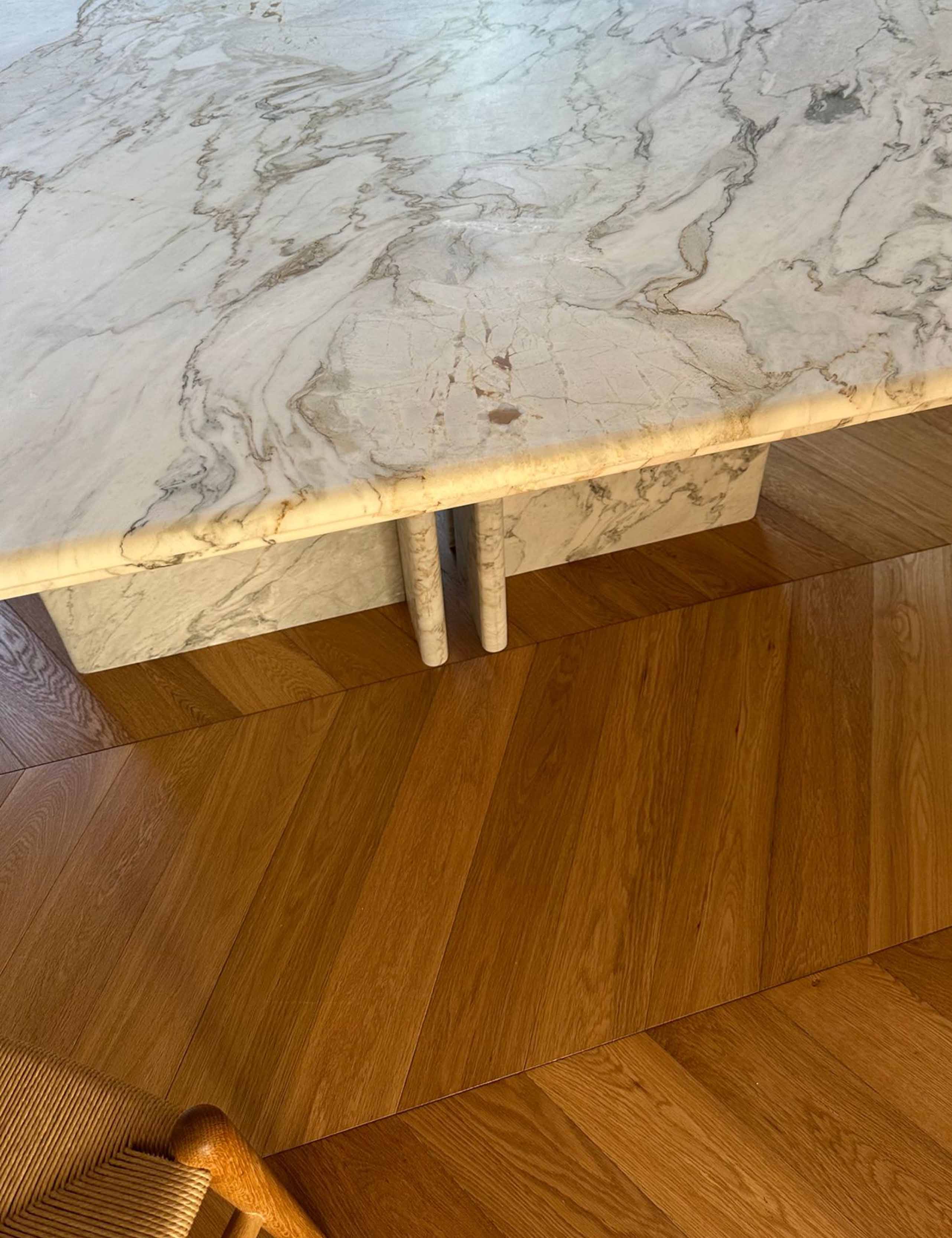 Detail of marble dining table top with rounded bullnose edge and natural veining.