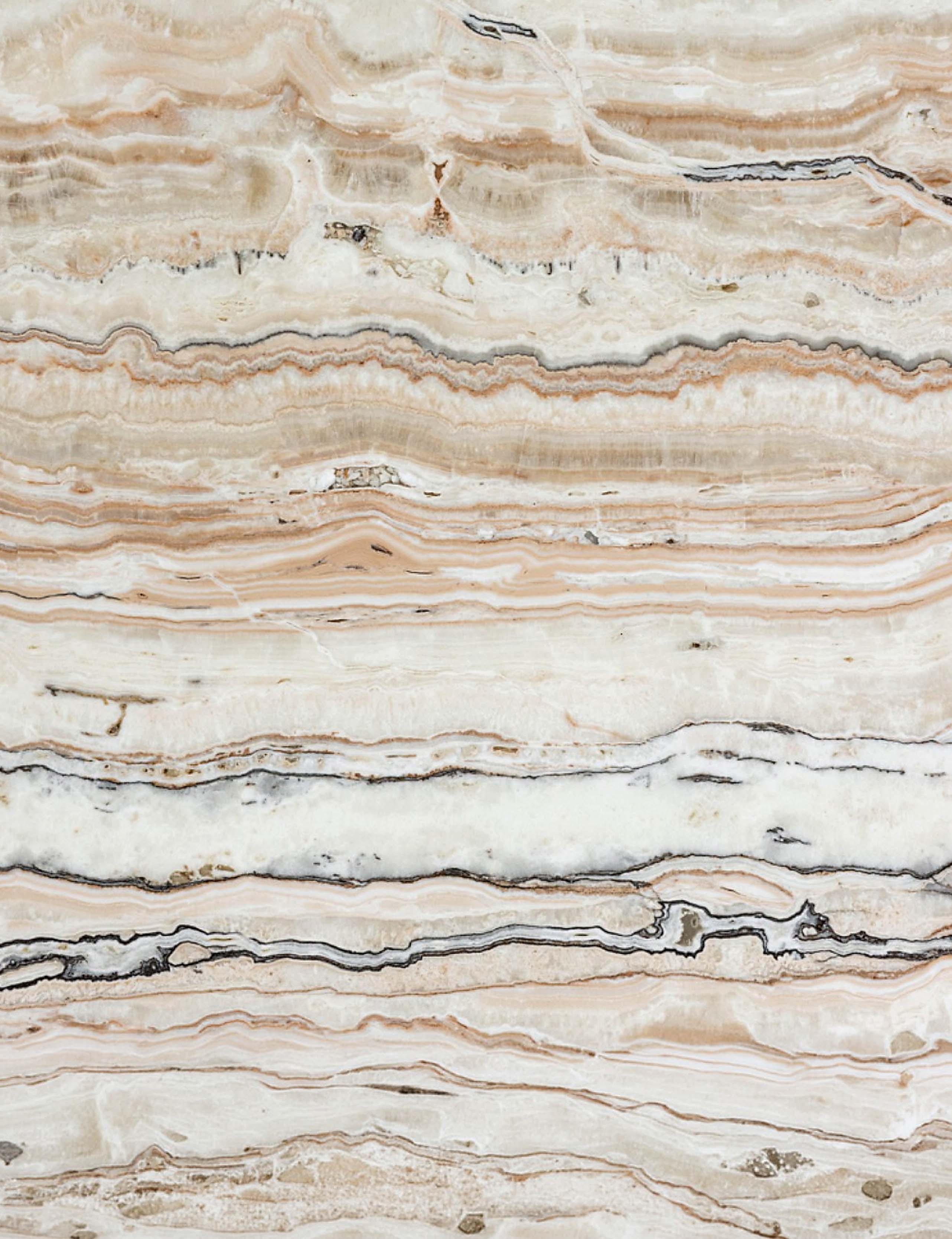 Close-up of Desert Linea Onyx natural stone showing warm layered veining and organic mineral patterns
