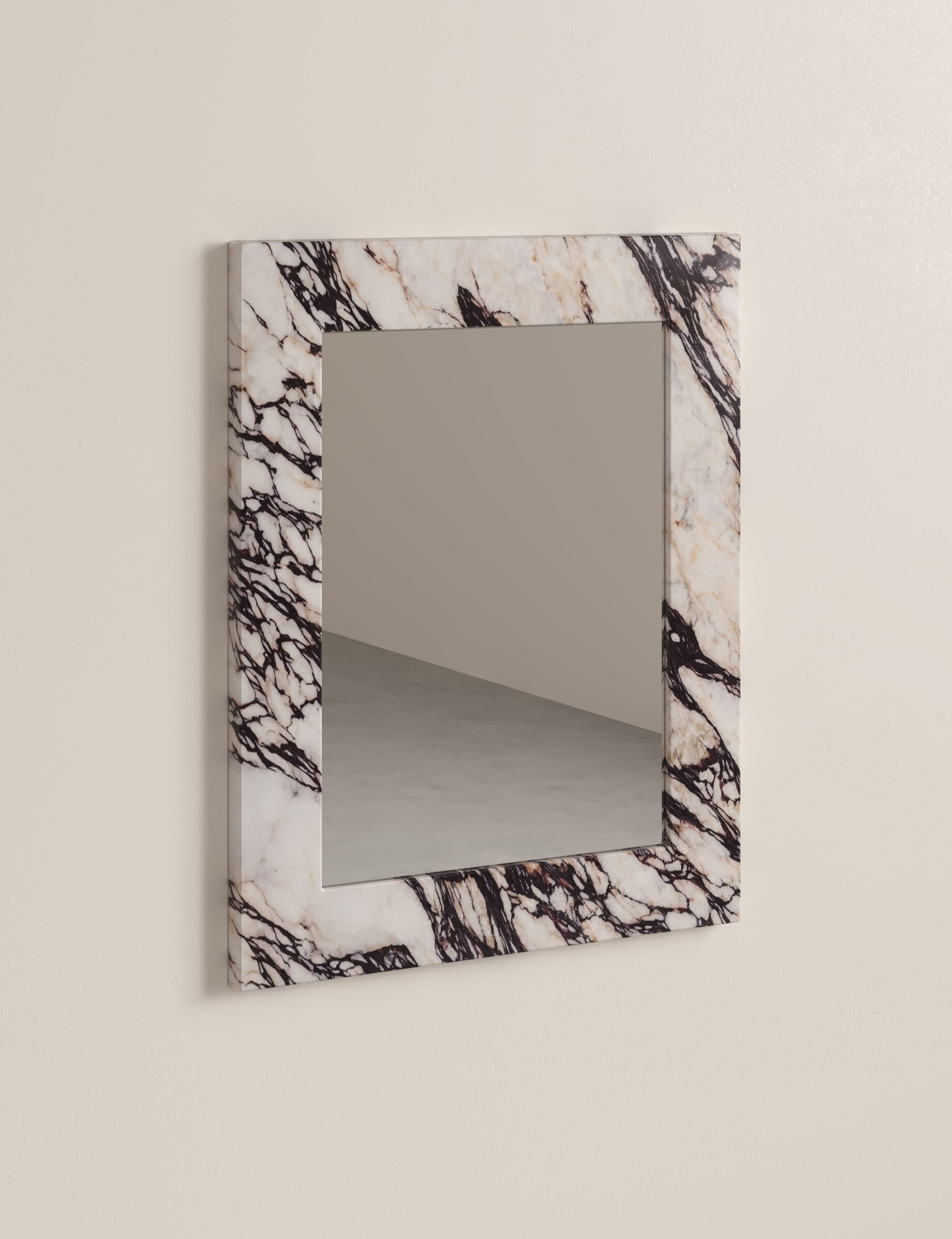 Opal Calacatta Viola marble wall mirror with dramatic burgundy veining in natural stone frame.