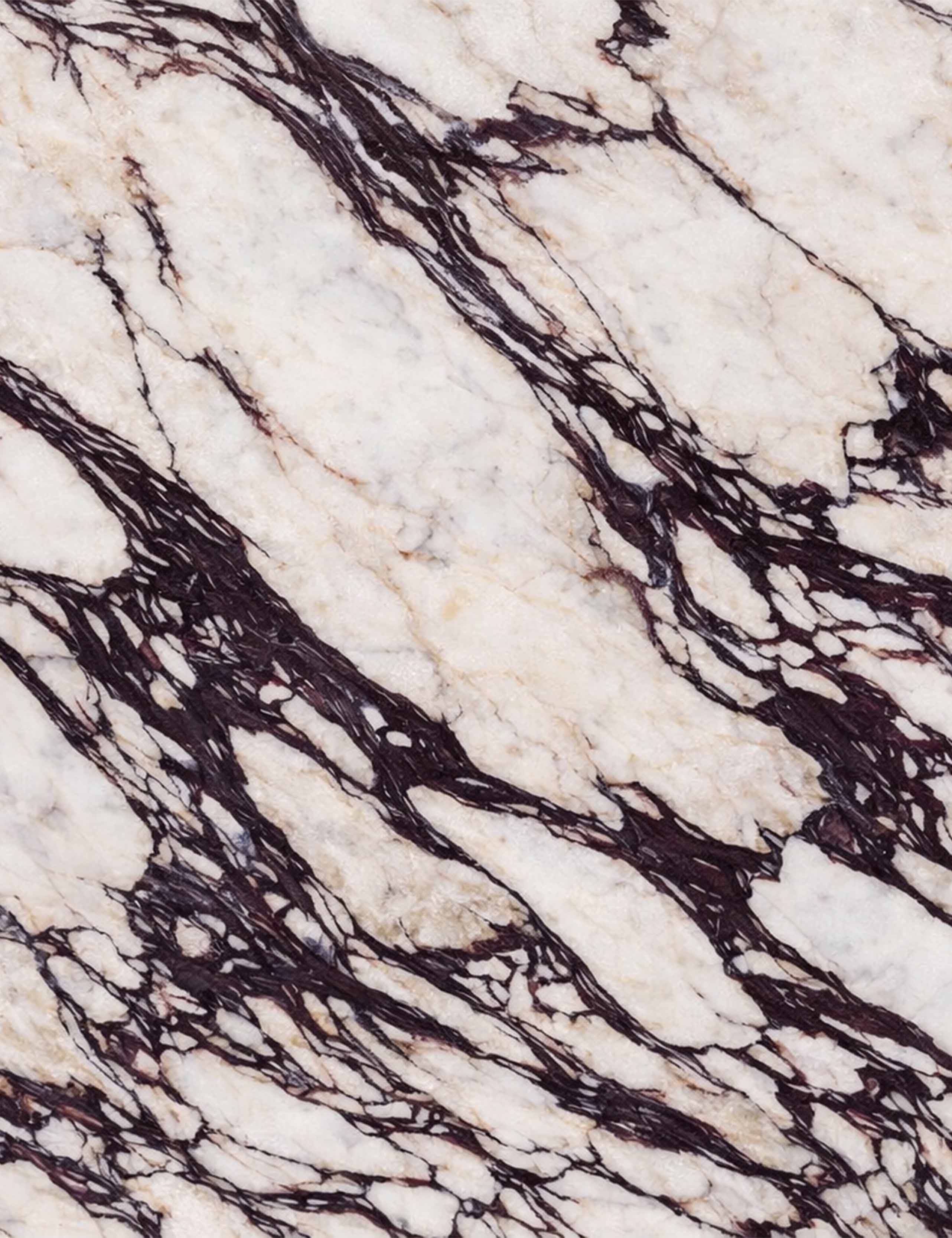 Close-up of Calacatta Viola marble with deep burgundy veining used for Opal marble mirror frame.